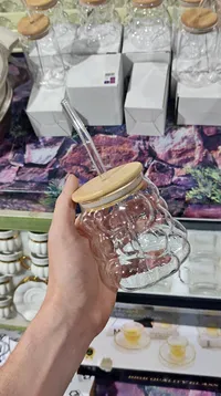 كوب زجاجي بتصميم مموج مع غطاء خشبي وقشة
