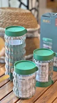 برطمان تخزين زجاجي بغطاء أخضر