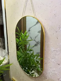 مرآة حائط بإطار ذهبي بيضاوية