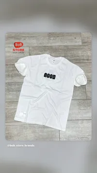 تيشيرت رجالي أبيض بكلمة جود - بوب ستور (Bob Store)