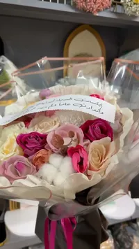 باقة زهور صناعية مع عبارة إهداء