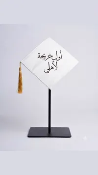 مجسم قبعة تخرج مكتوب عليها أول خريجة لأهلي