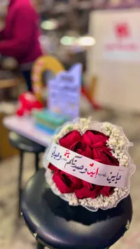 باقة ورود حمراء مع رسالة حب مكتوبة